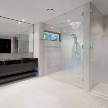 Luxury bathroom with mirrors, sink, shower and toilet