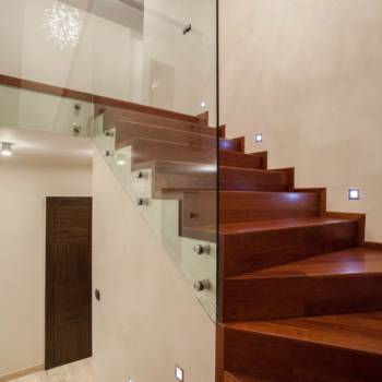 Travertine house - Wooden glass staircase in modern interior